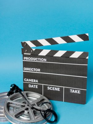 clapperboard-with-film-reel-film-stripes-against-blue-backdrop